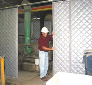 Worker setting up soundproof curtain